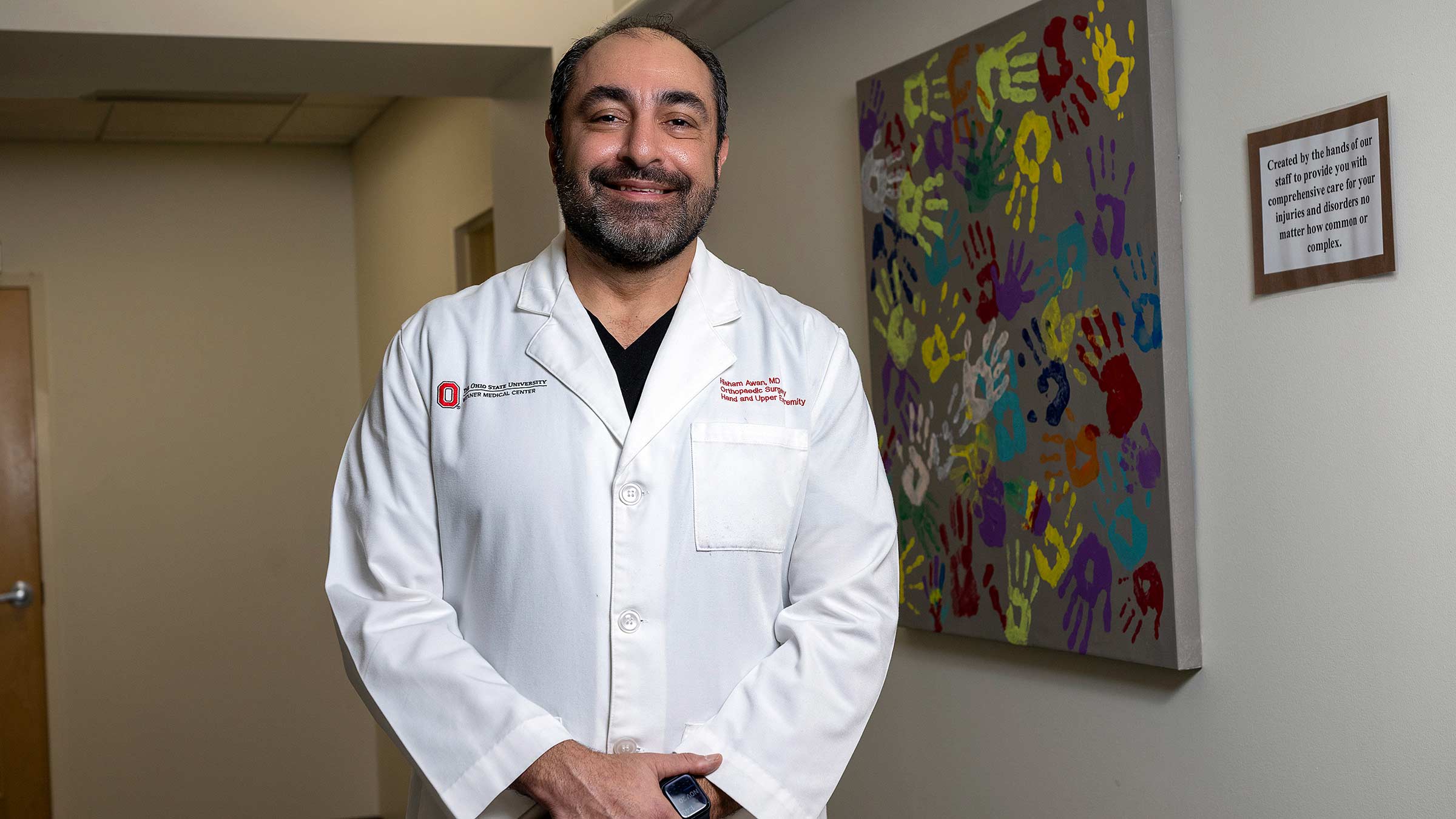 Hisham Awan, MD, standing in a hallway