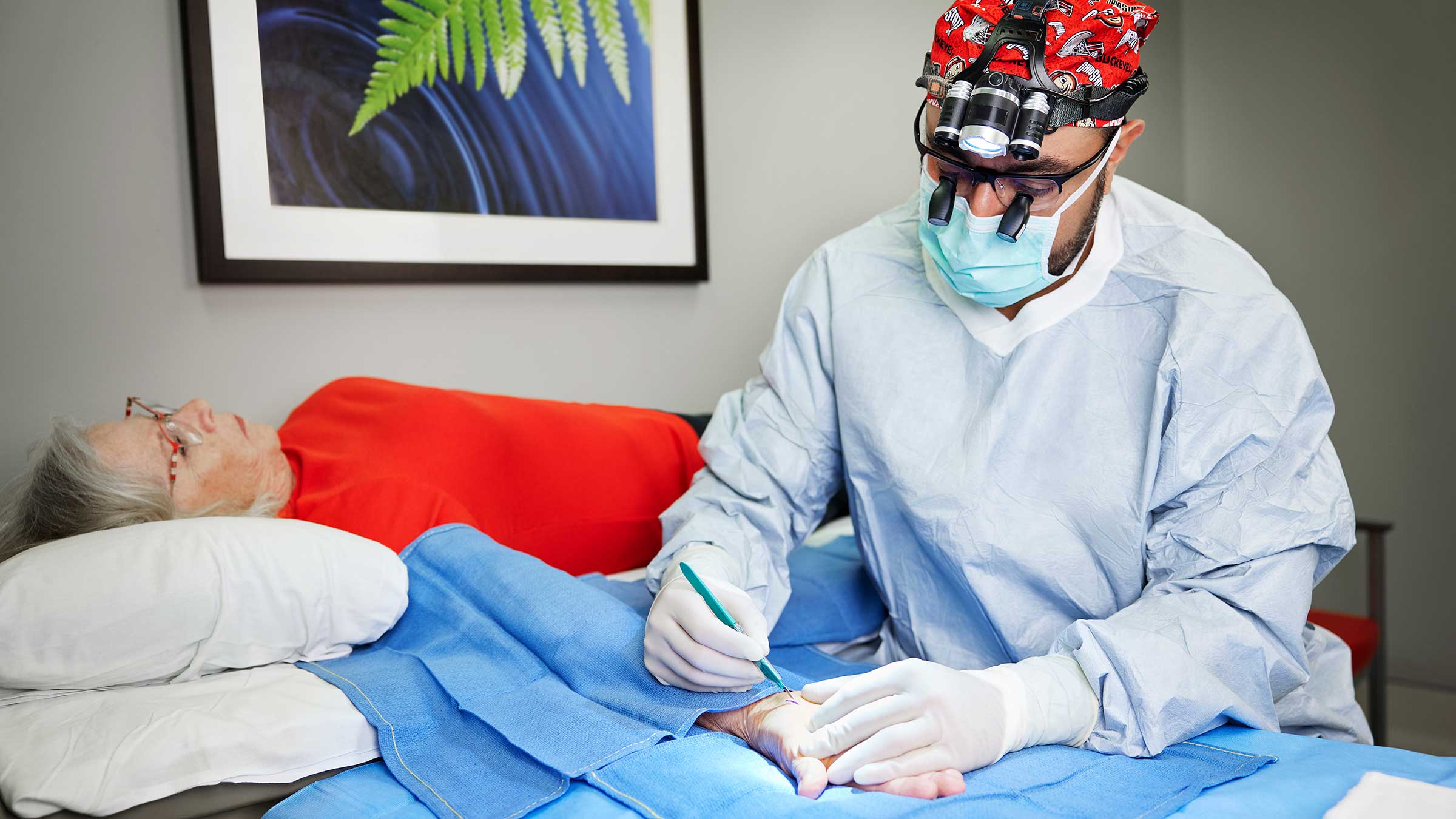 Dr. Awan performing a wrist surgery on a patient