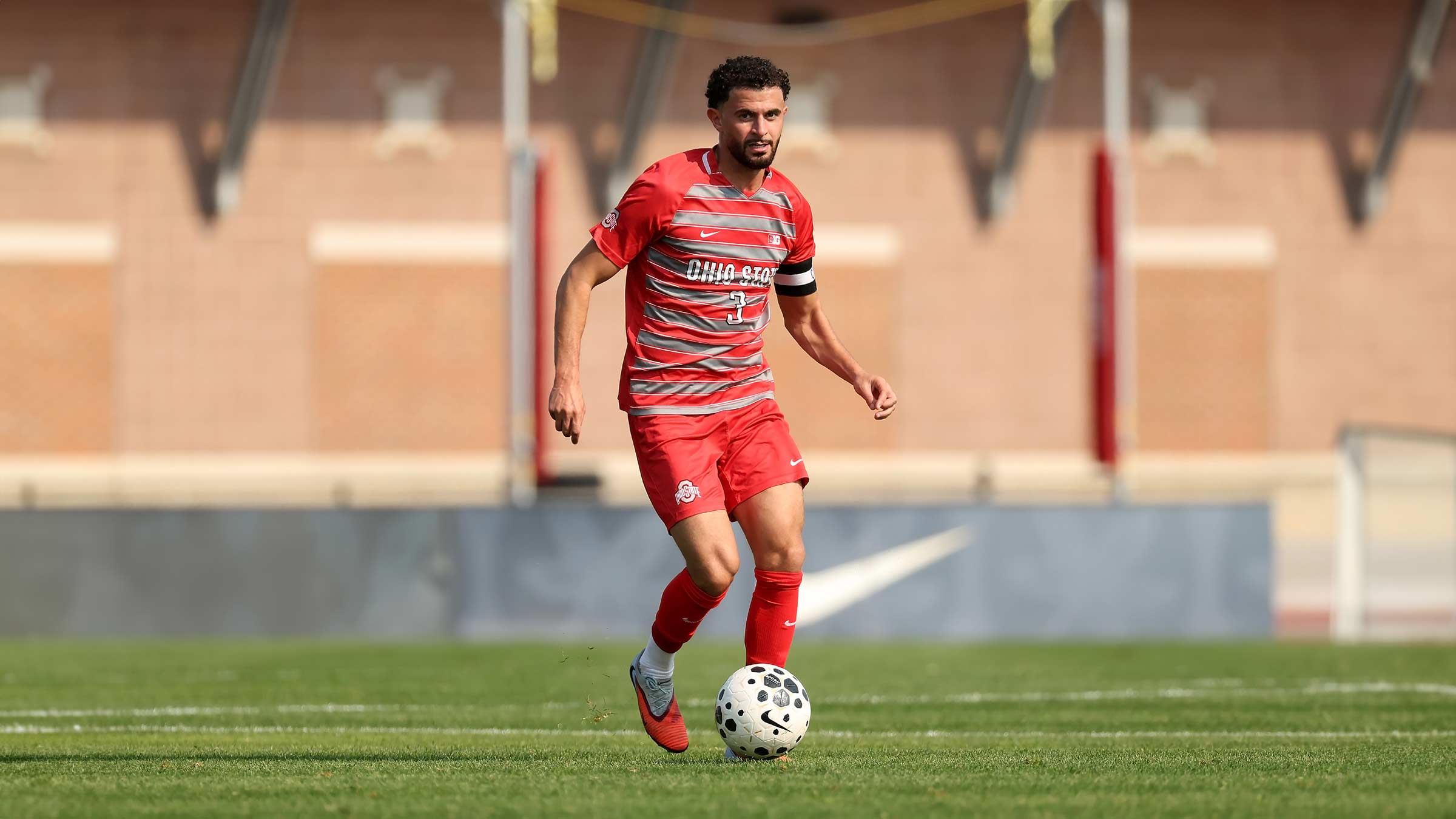 Ohio State soccer player, Nathan, dribbling a soccer ball on the field