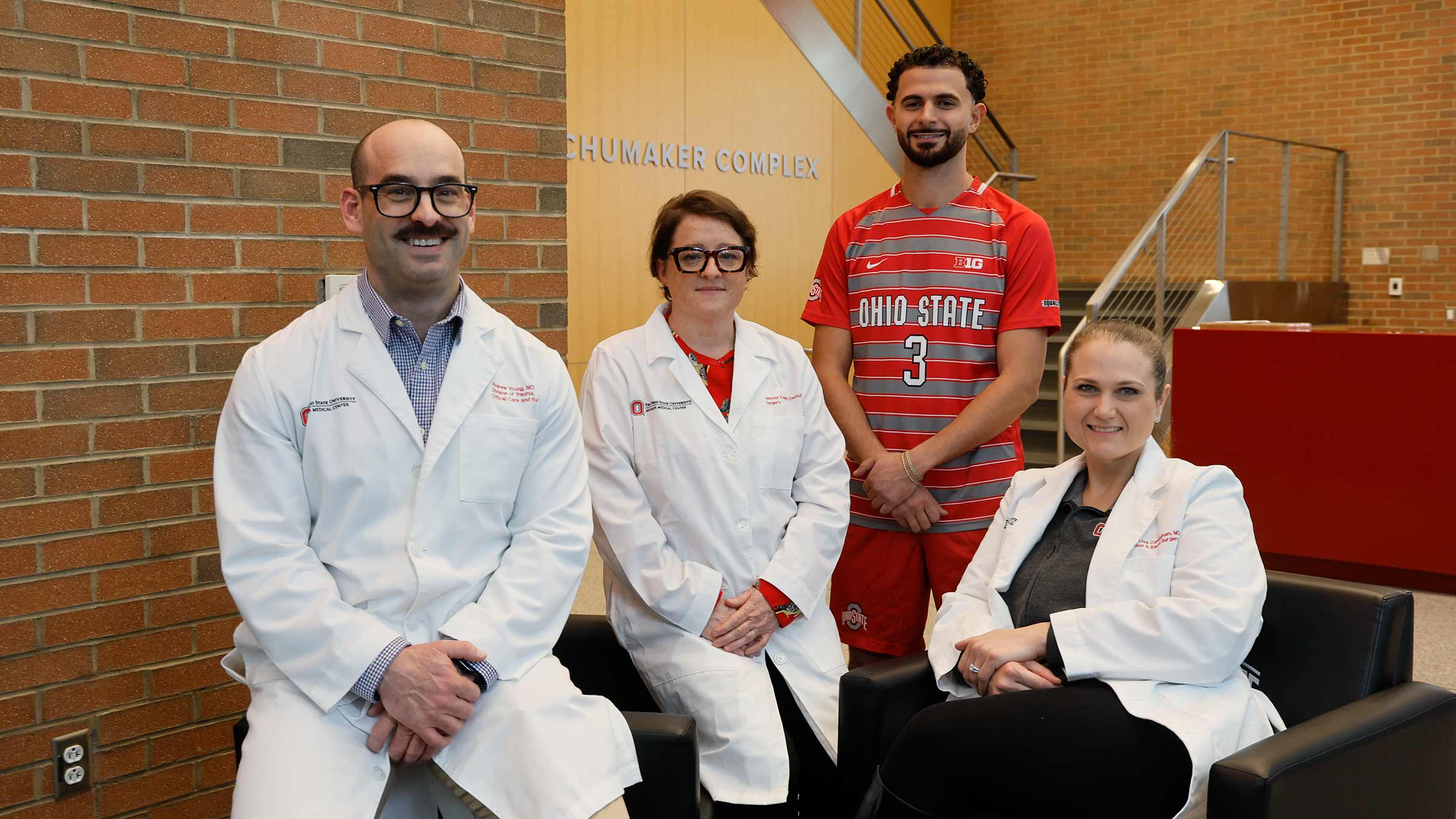 Nathan Demian and his trauma surgery team in the lobby of the Shumaker Complex