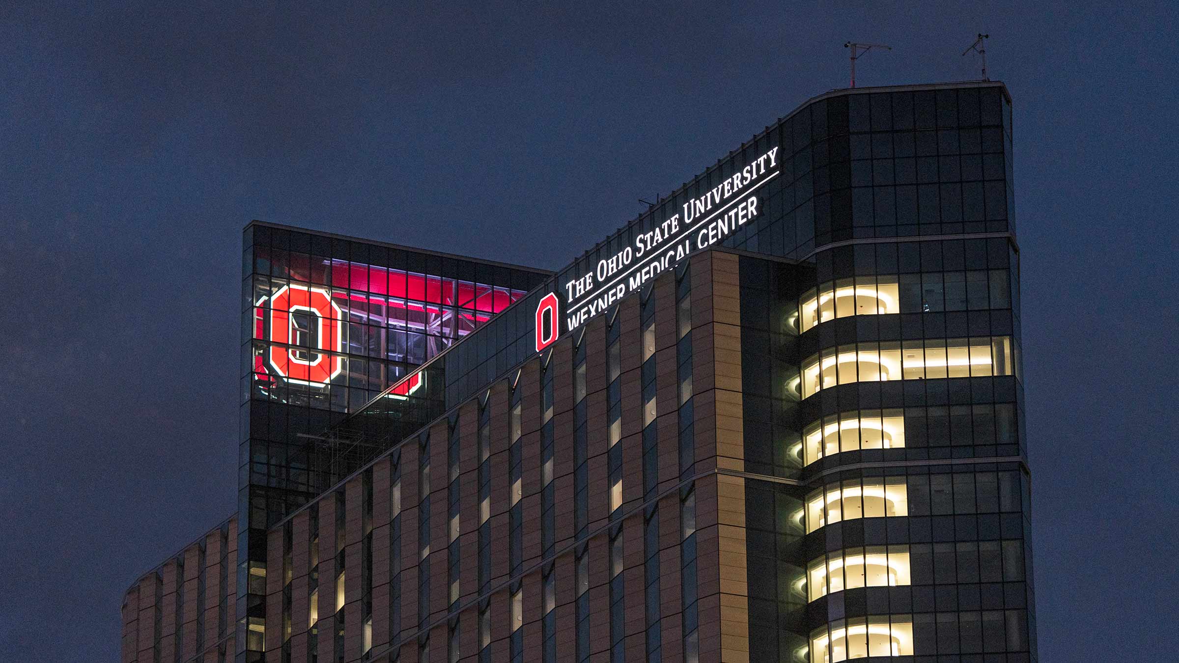 The new Ohio State University Hospital exterior with the Block O lit up at night