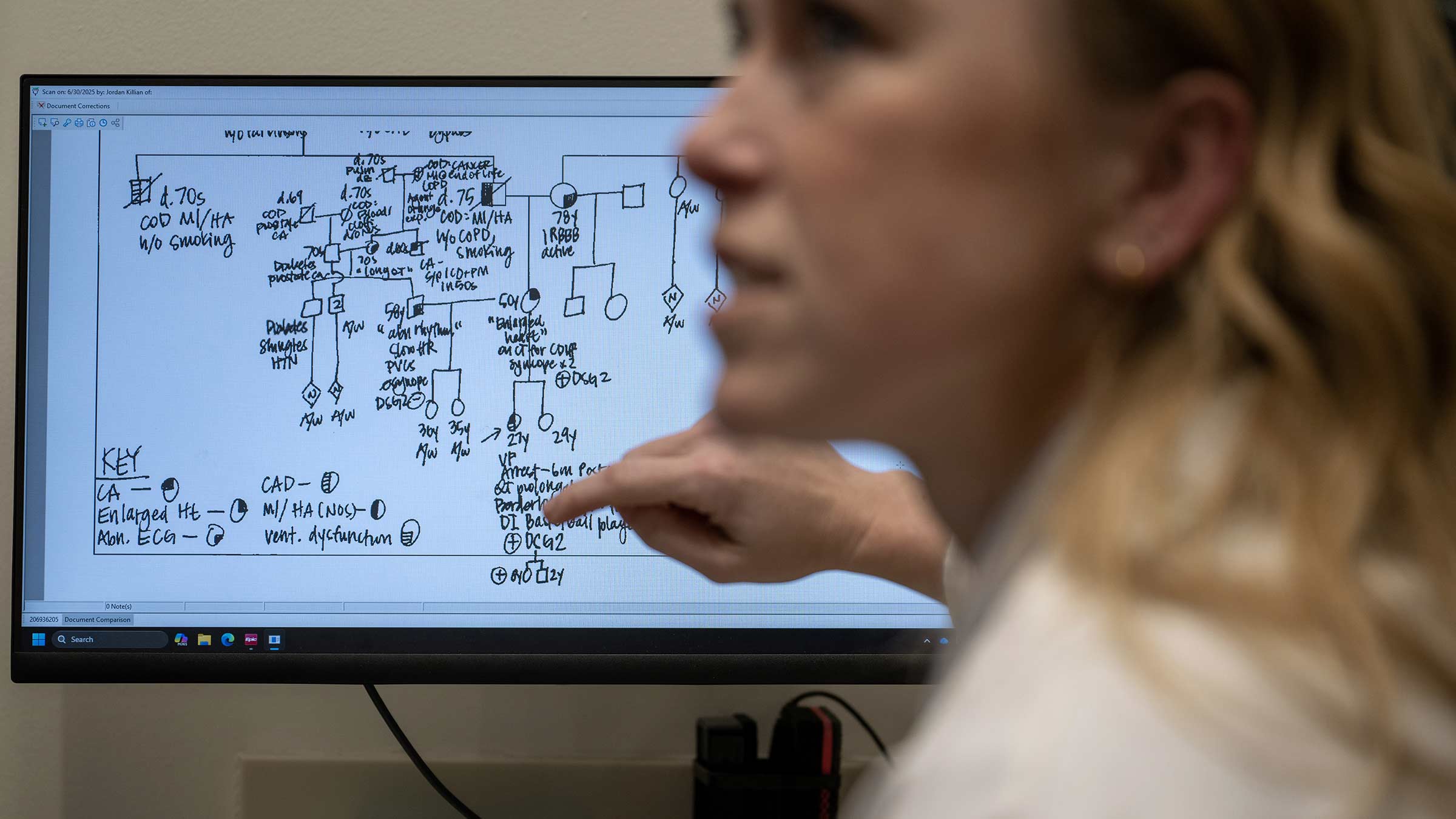A geneticist explaining results from a genetic screening