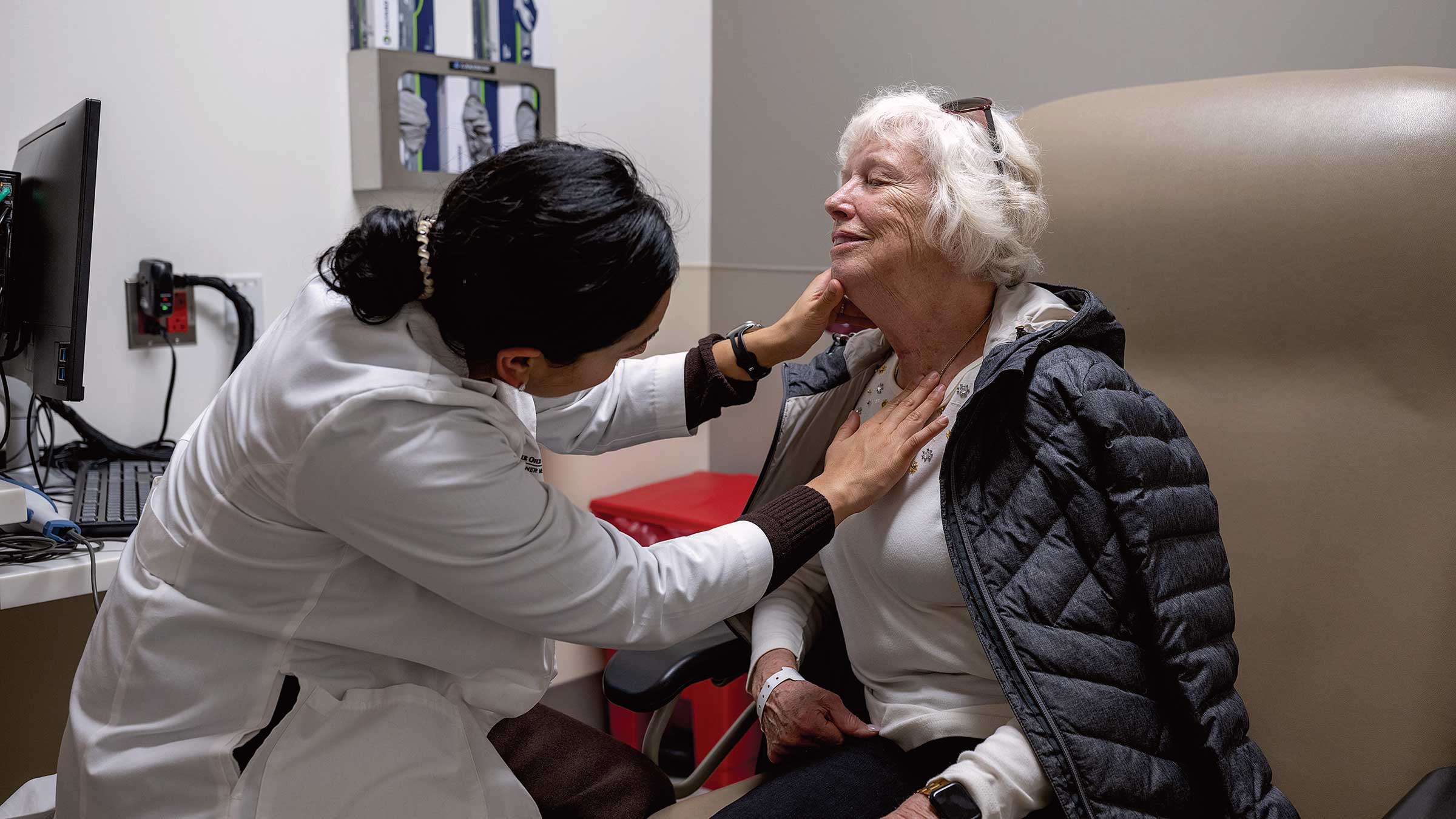Dr. Apoorva Ramaswamy checks the throat of an elderly woman in Ohio State's swallowing clinic