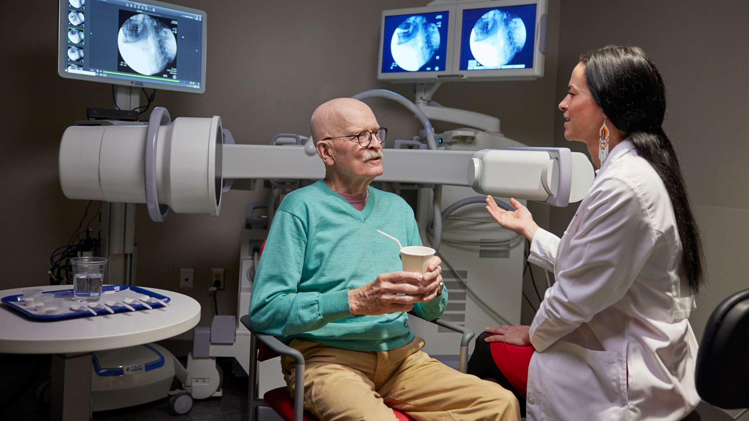 Dr. Plowman consults with a male patient in the clinic