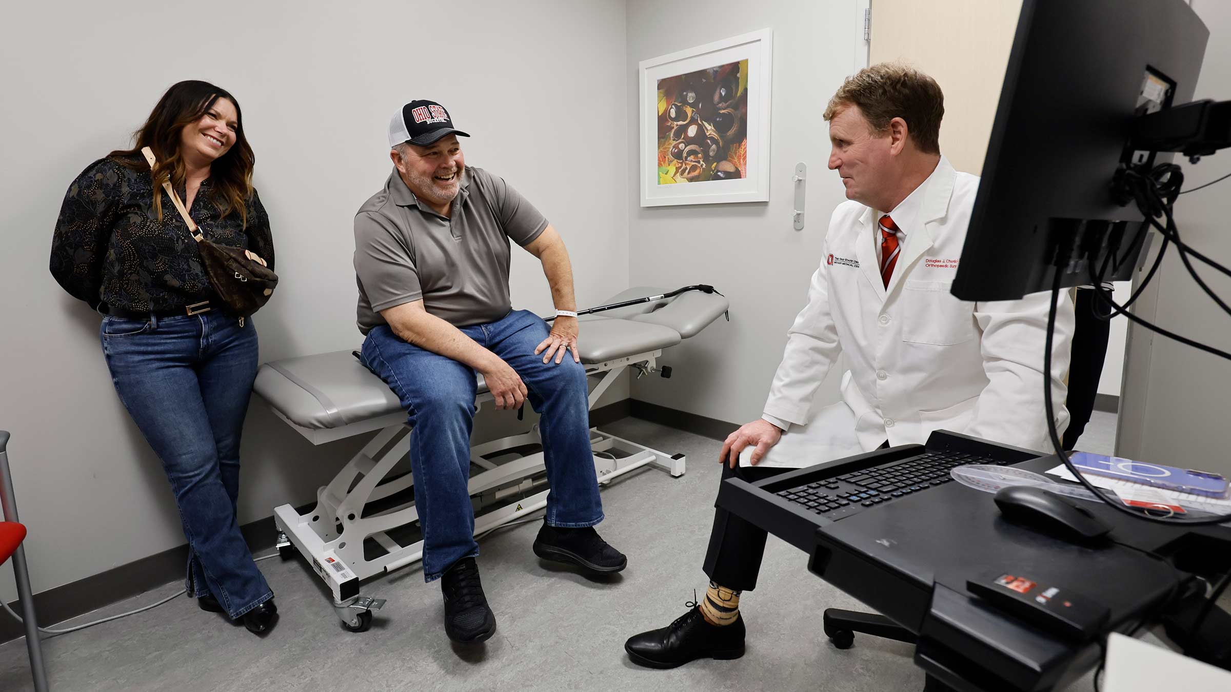 Patient, Brian Lewis and his wife meet with Dr. Chonko in a clinical setting