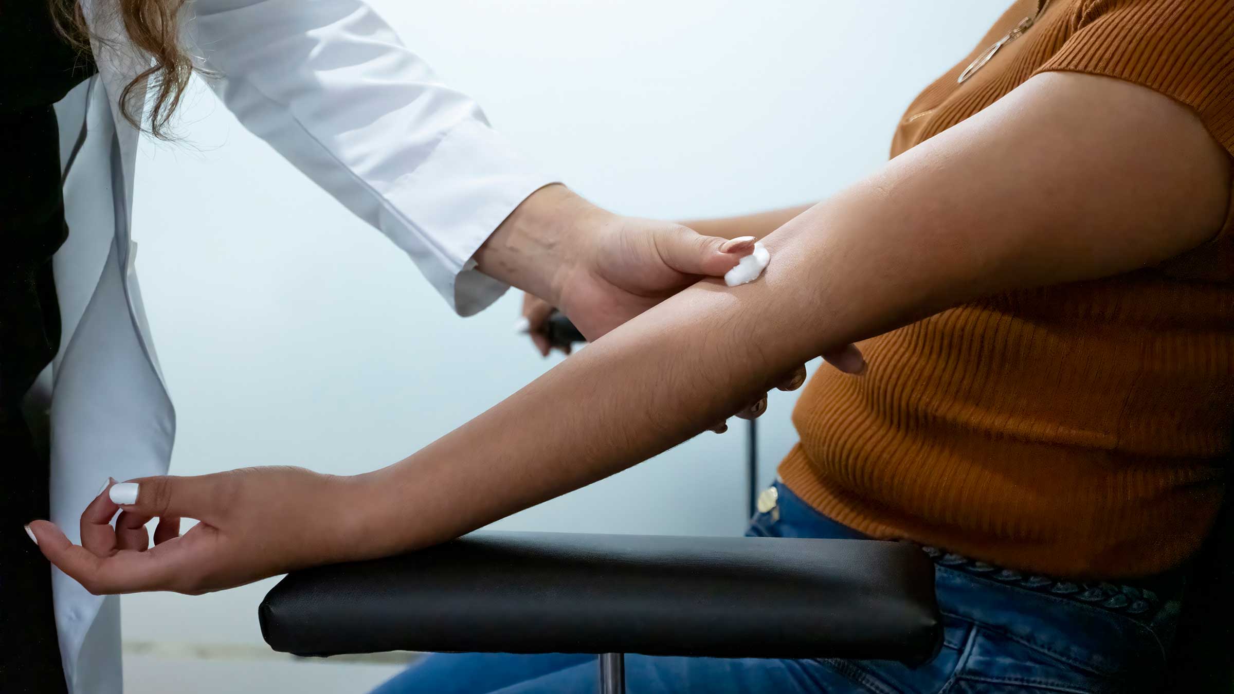 A nurse taking a blook sample from a patient's arm