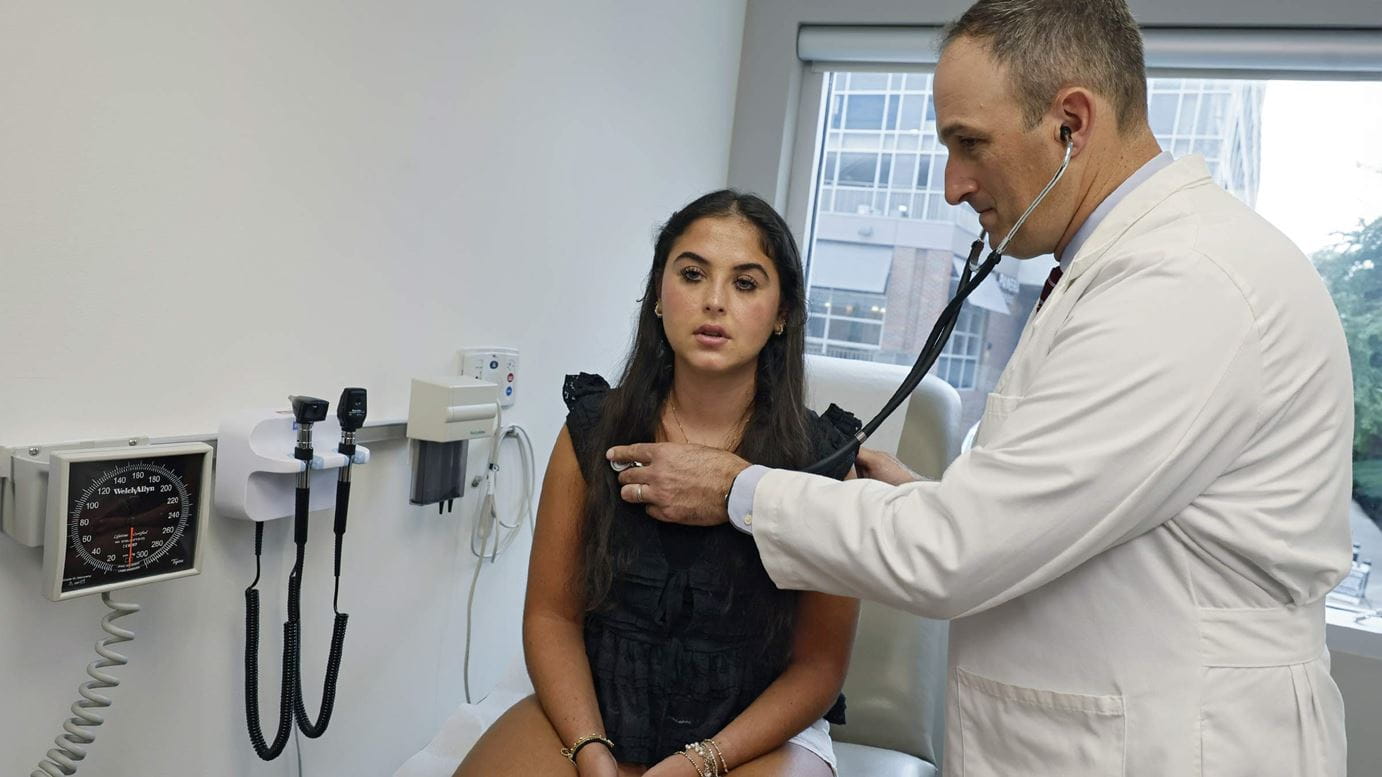 Pulmonologist, Dr. Stephen Kirkby, examining patient, Ella Dubro, with a stethoscope