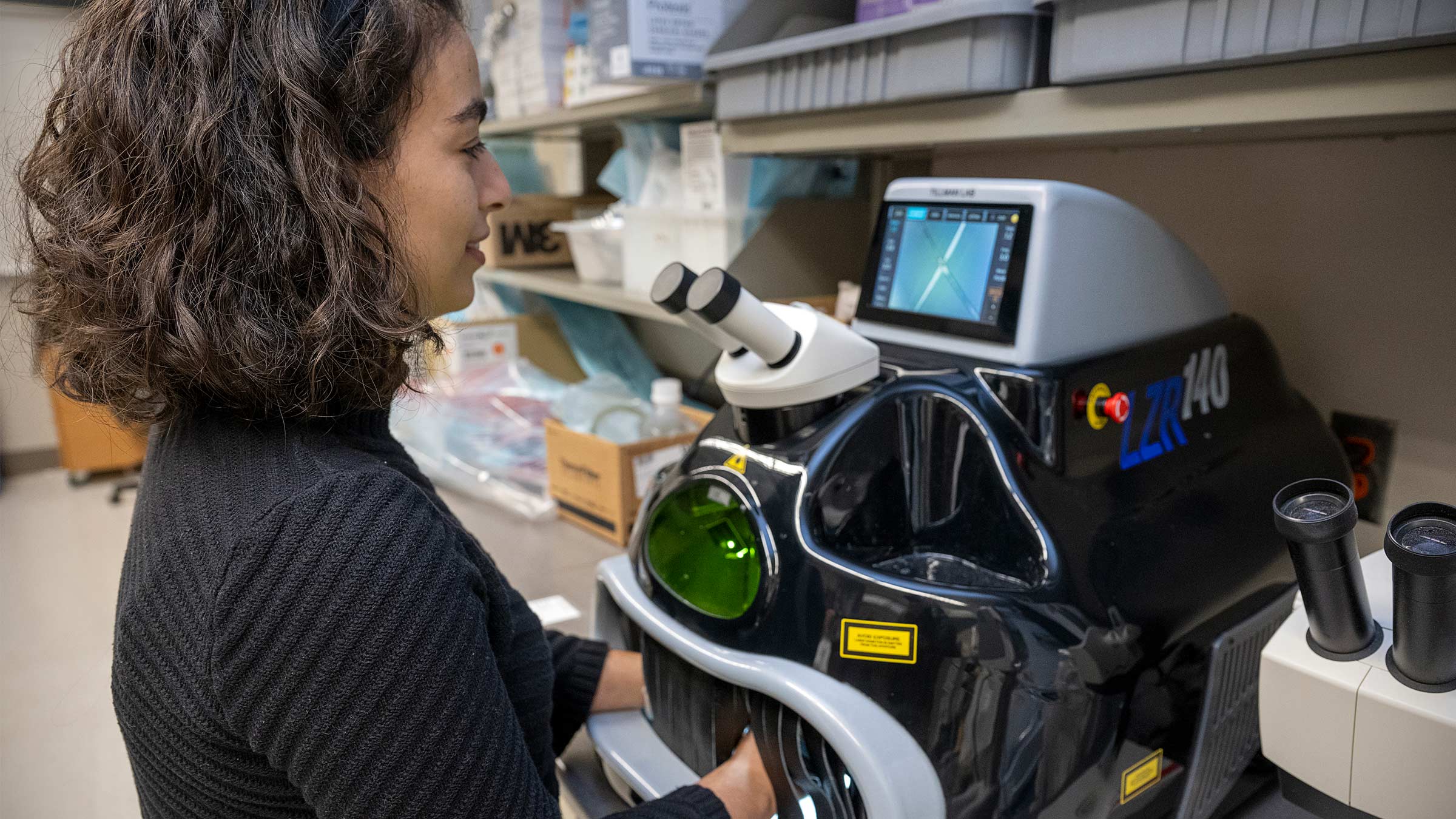 Surgical resident Dahlia Kenawy, MD, uses a laser welding machine to assemble parts of the prototype retrievable stent together.