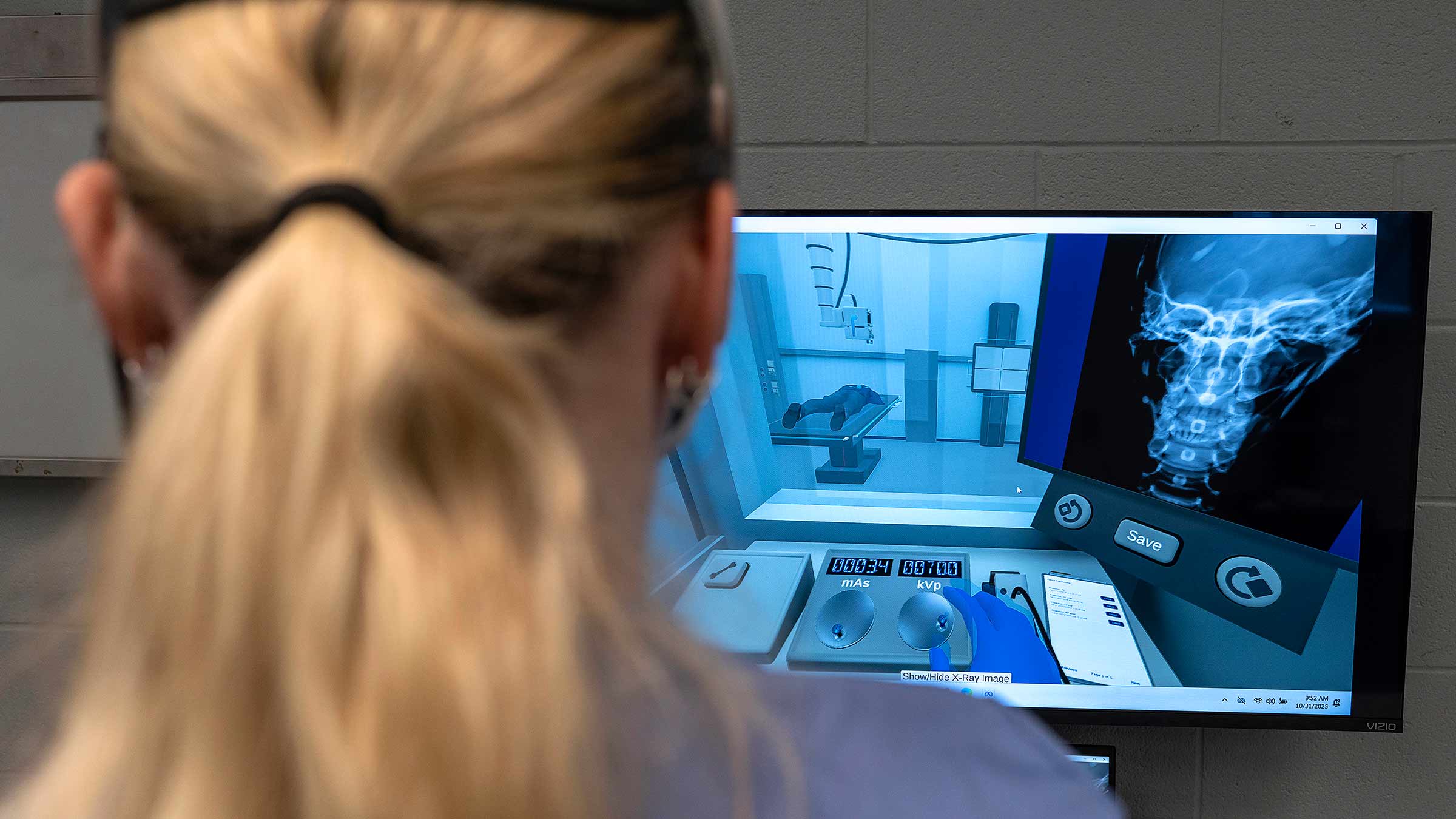 Student using a virtual reality headset facing an imaging screen