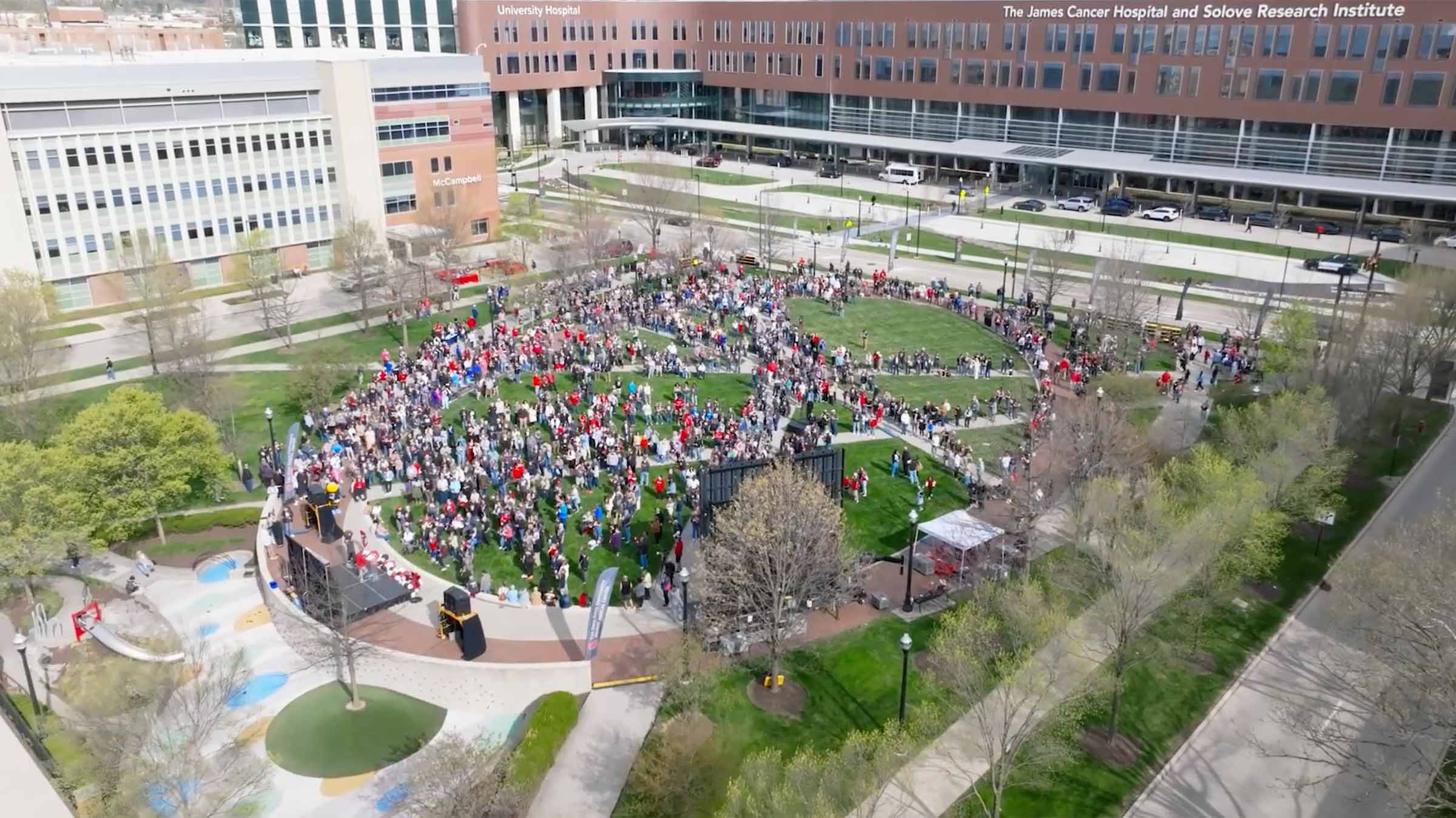 Overhead shot showing a crowd gathered in front of the OSUCCC - James building