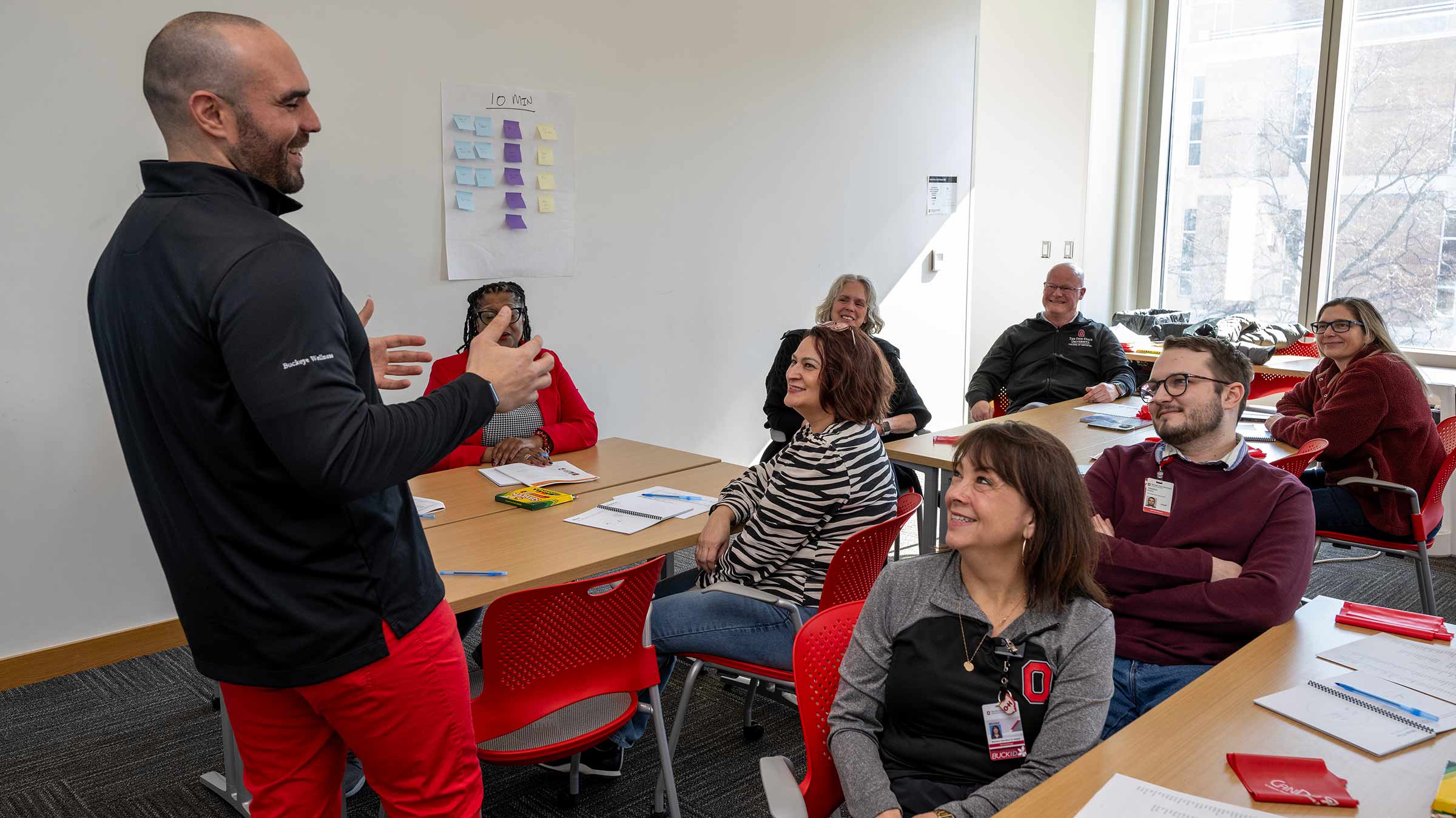 A Health athlete coach leading an in-person Health Athlete session in a brightly lit room