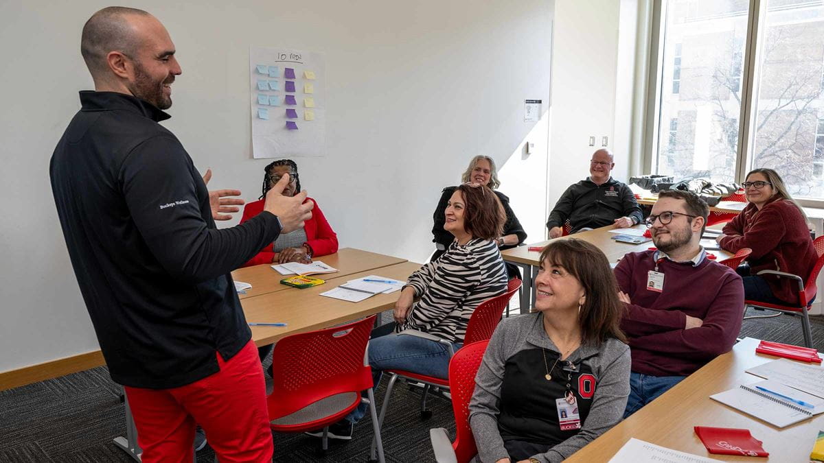 A Health athlete coach leading an in-person Health Athlete session in a brightly lit room