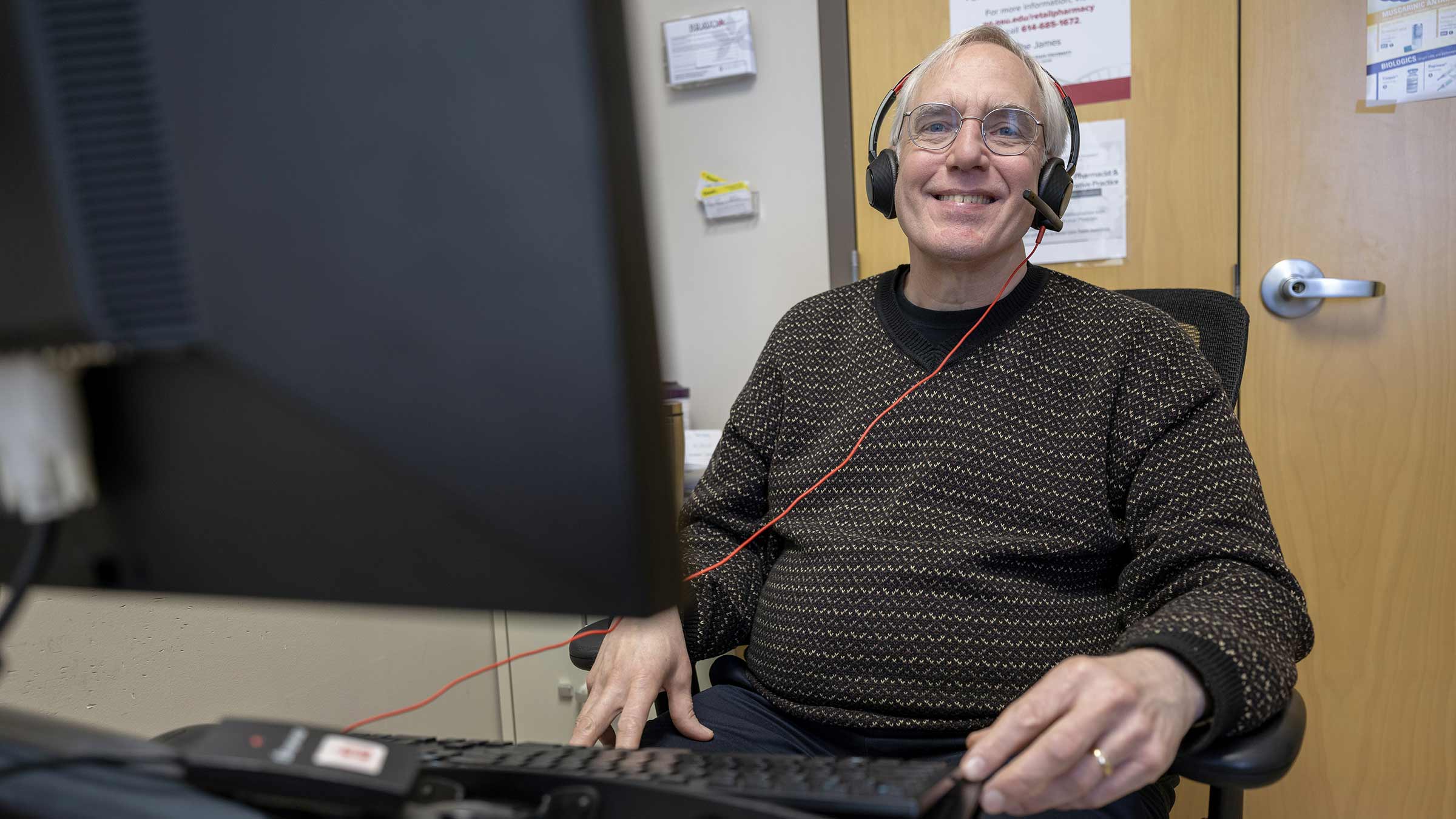 Steven Krause wearing headphones sitting in front of a computer
