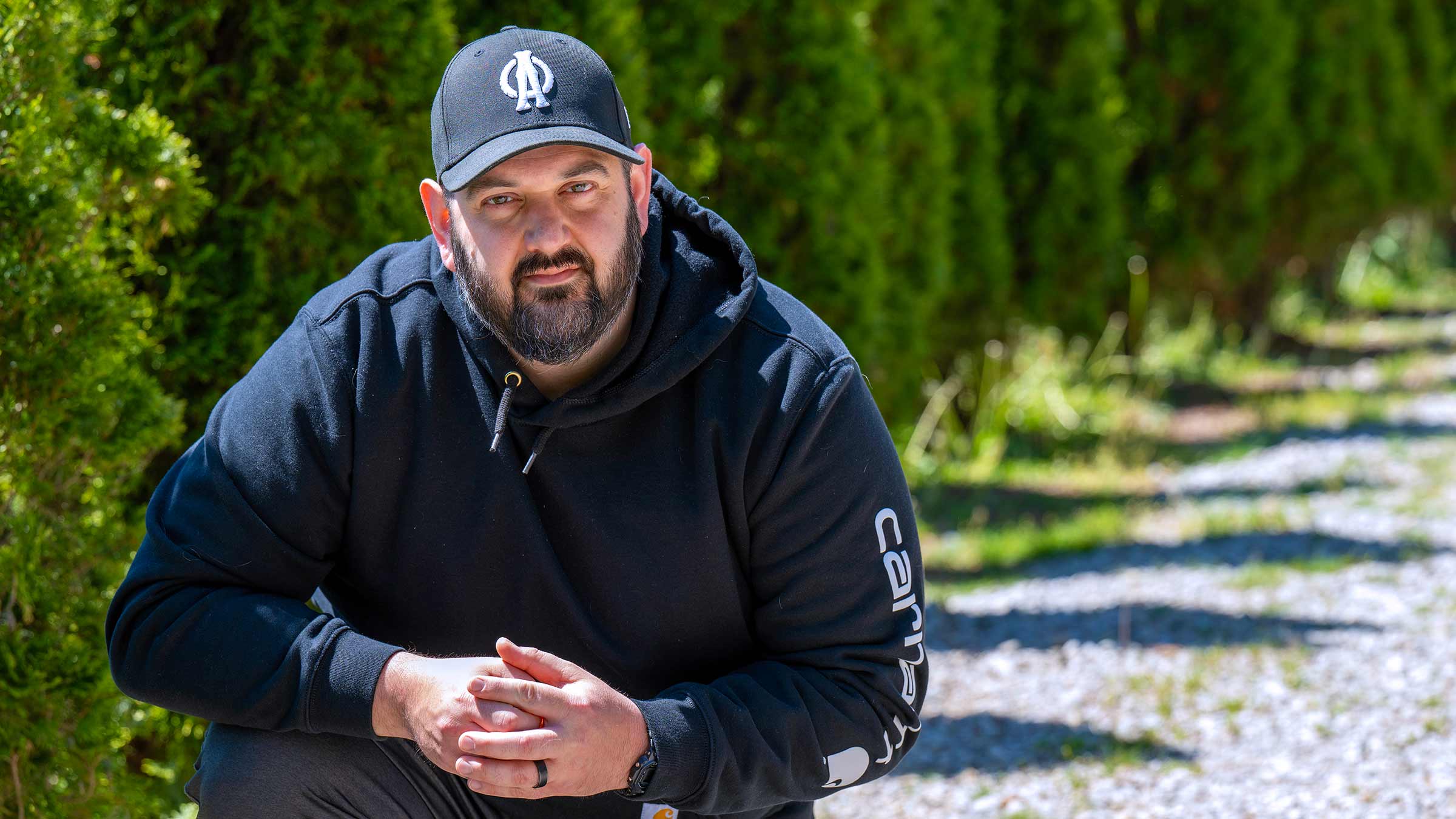 Patient, Alex Toomey, outside on his property