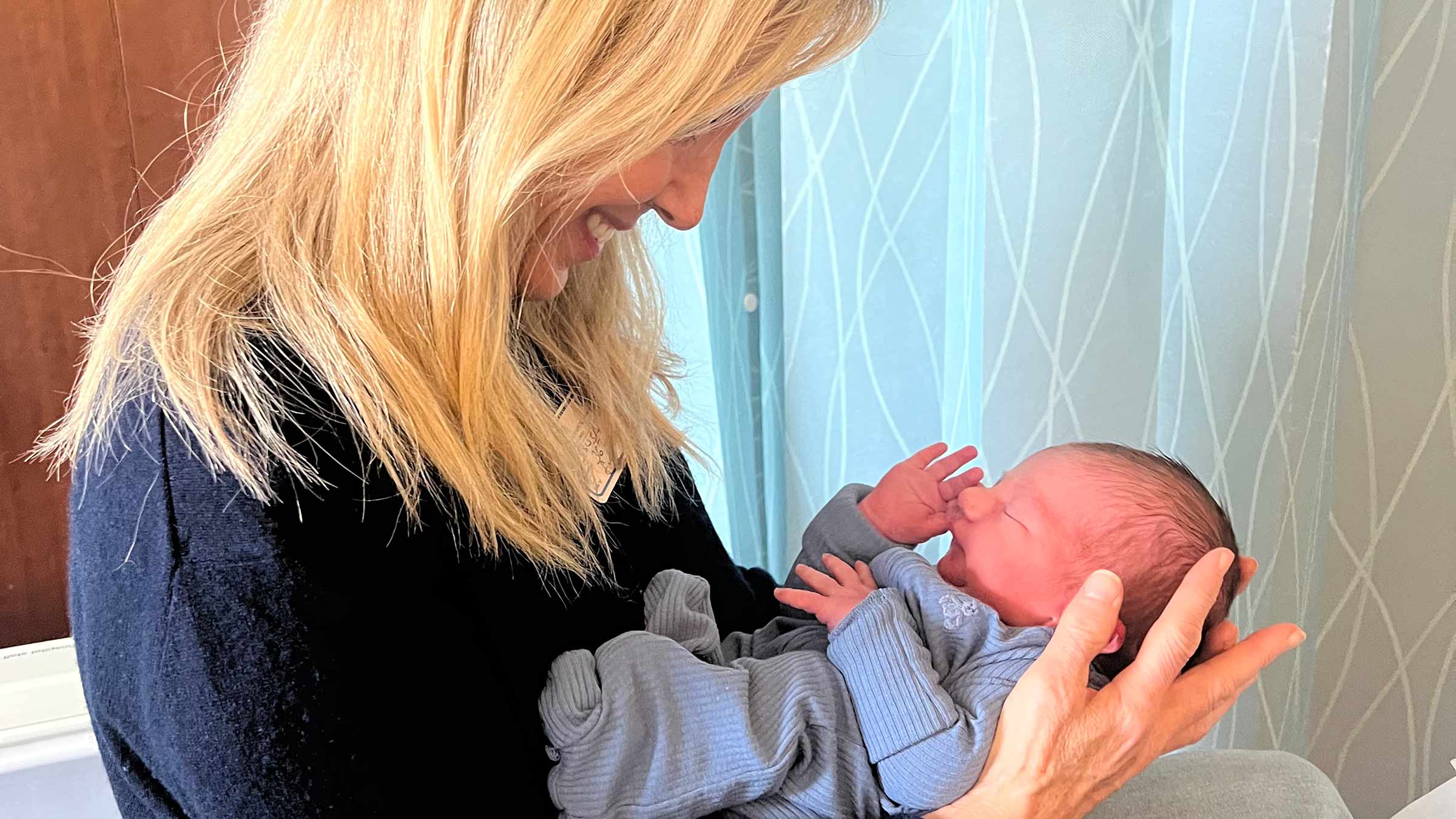 Patient, Laura Kindelt, holding a baby