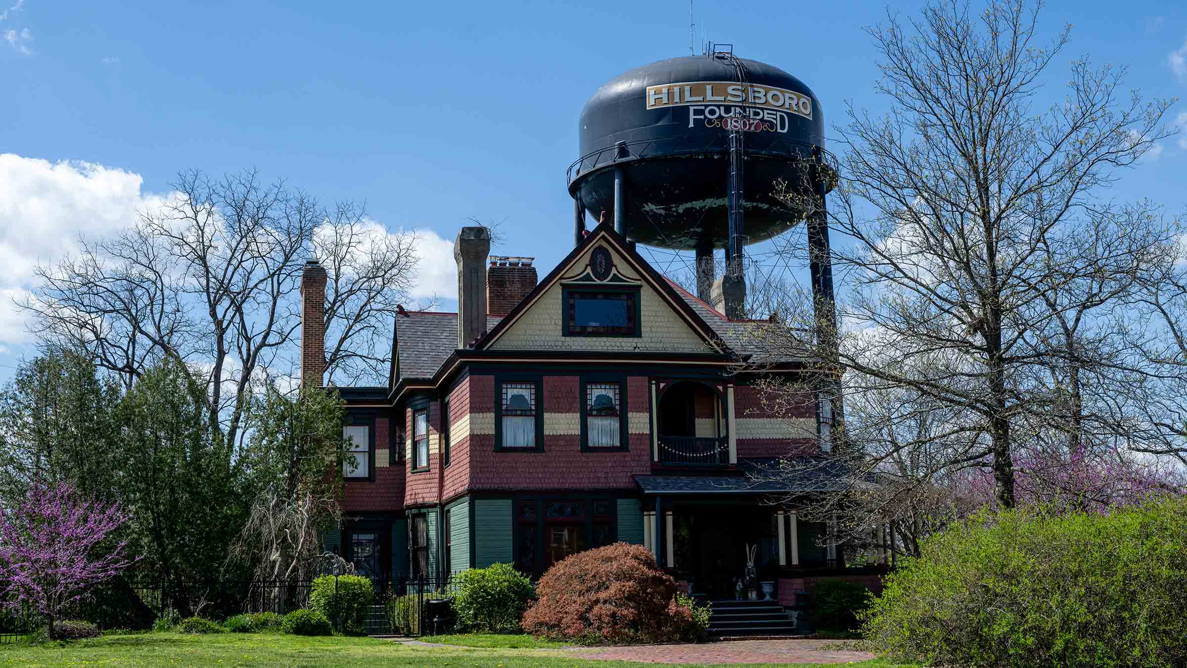 A home next to the water tower with "Hillsboro" written on it