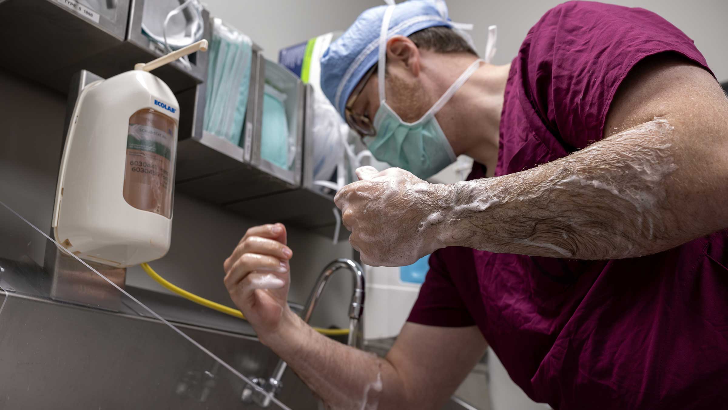 Patrick Sweigert, MD, scrubbing in