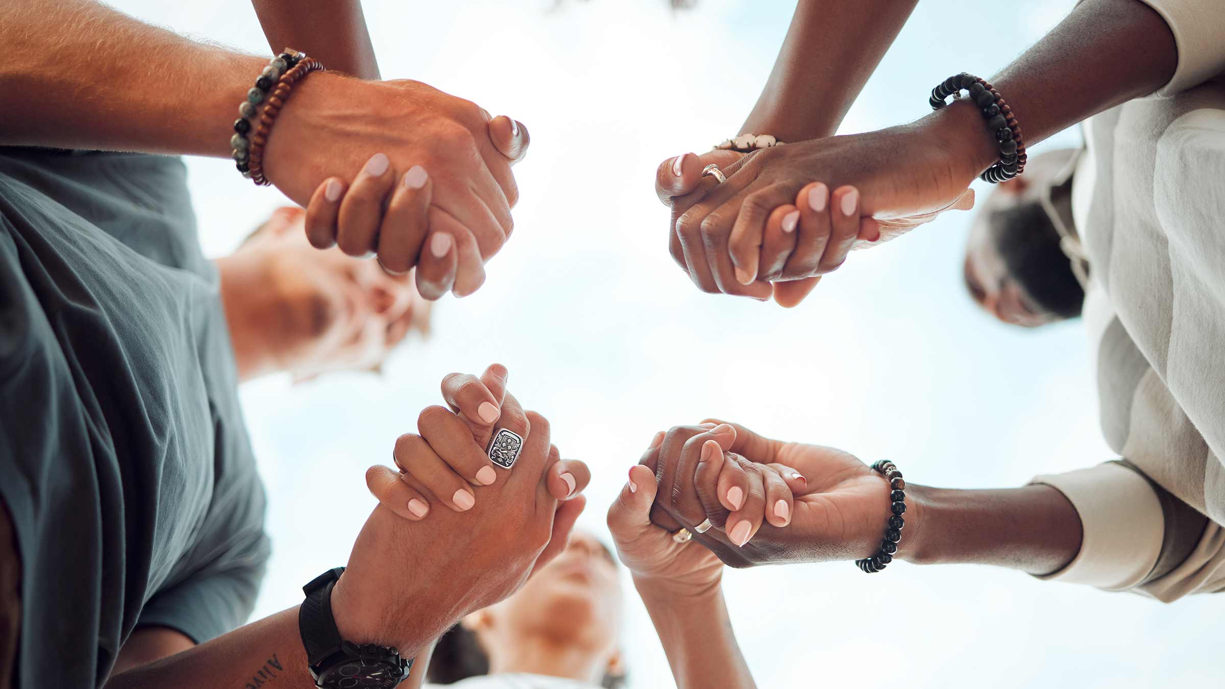People joining their hands in a circle