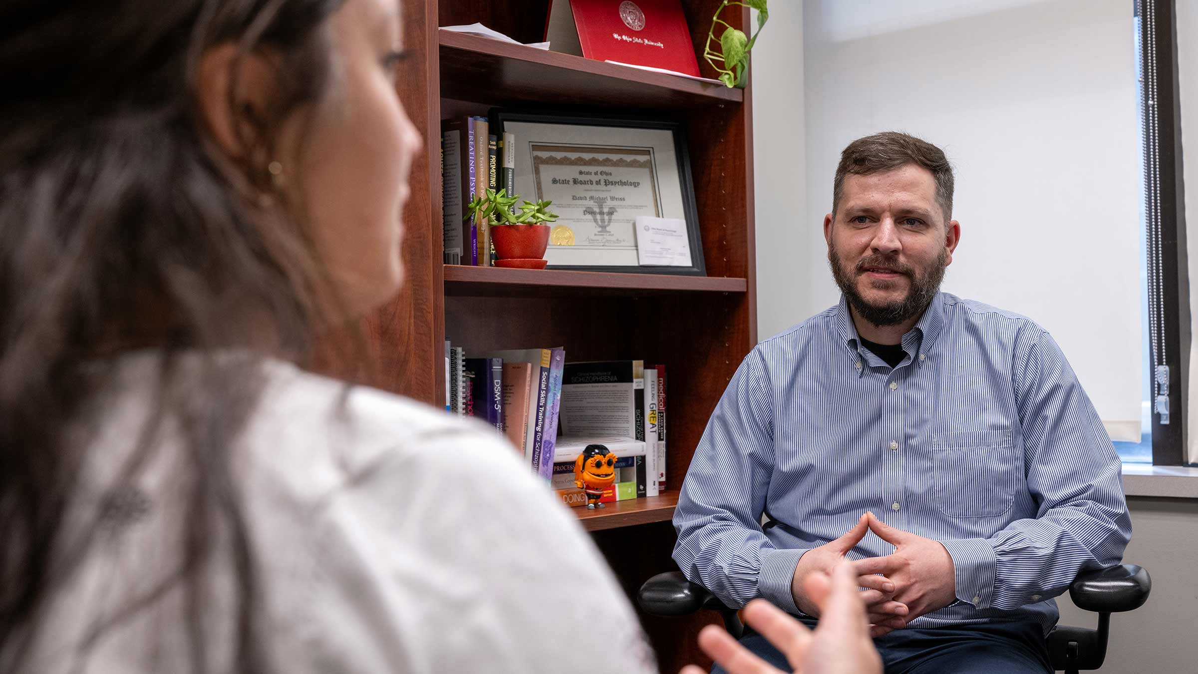 David Weiss, PhD, talking to a patient