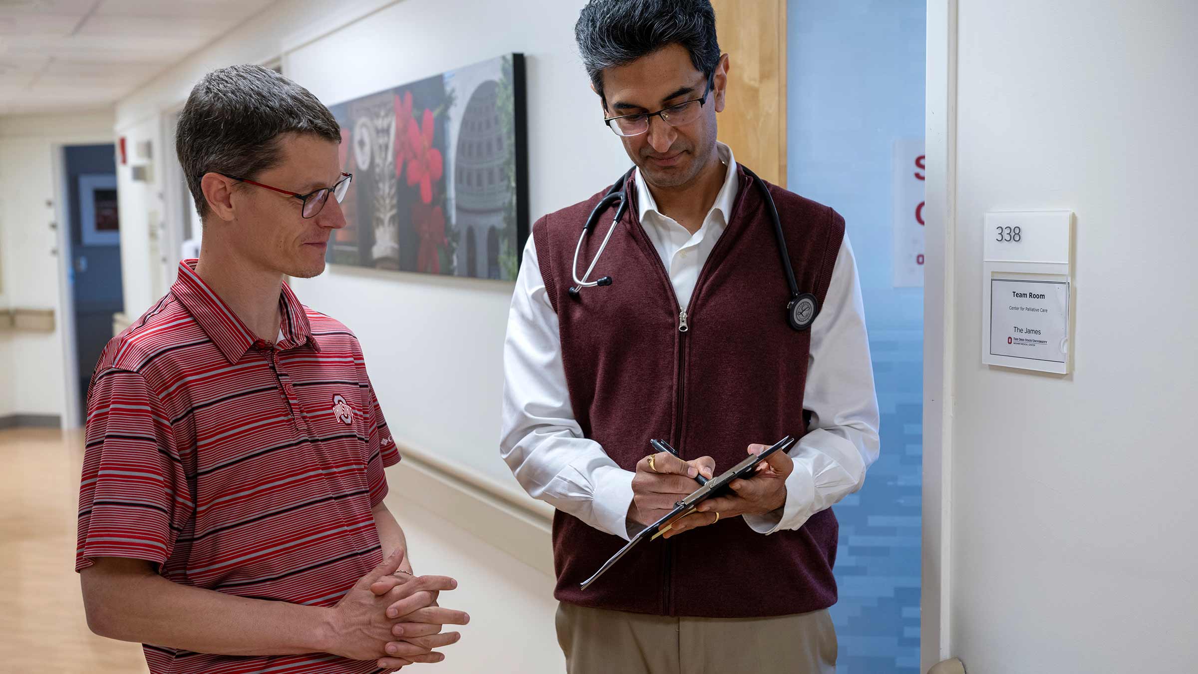 Dr. Sachin Kale and a clinical team member discuss a patient’s treatment plan