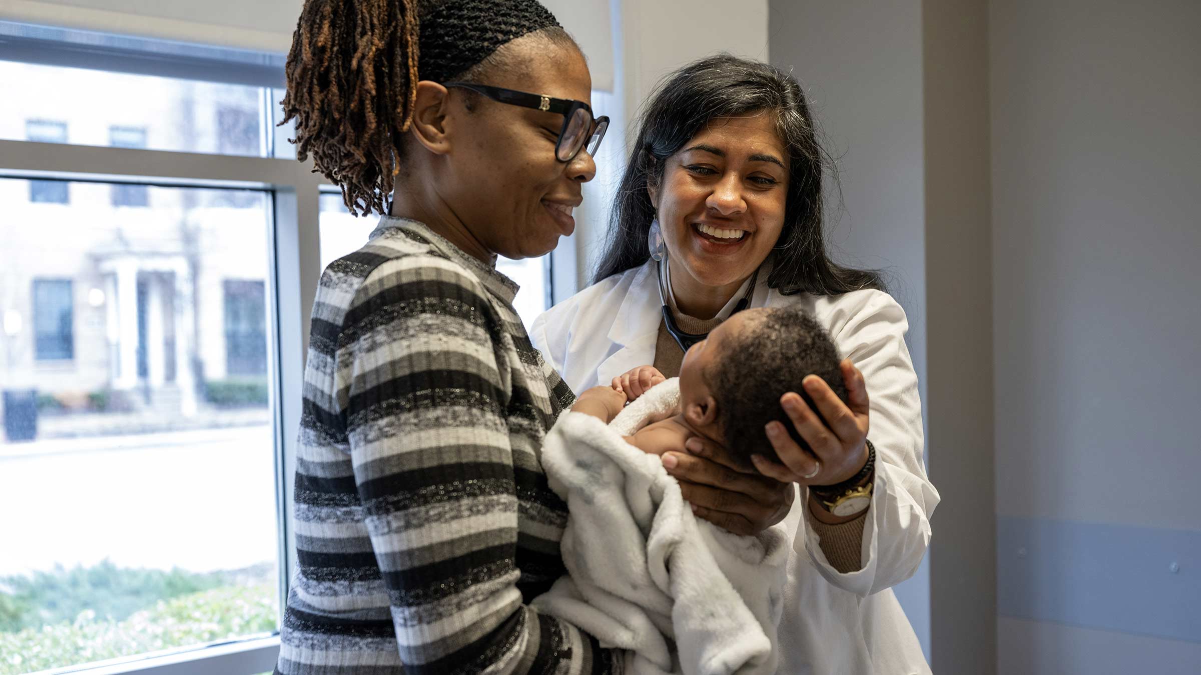 Dr. Brill and Lachaela Brooks holding Brooks’ infant during a primary care visit