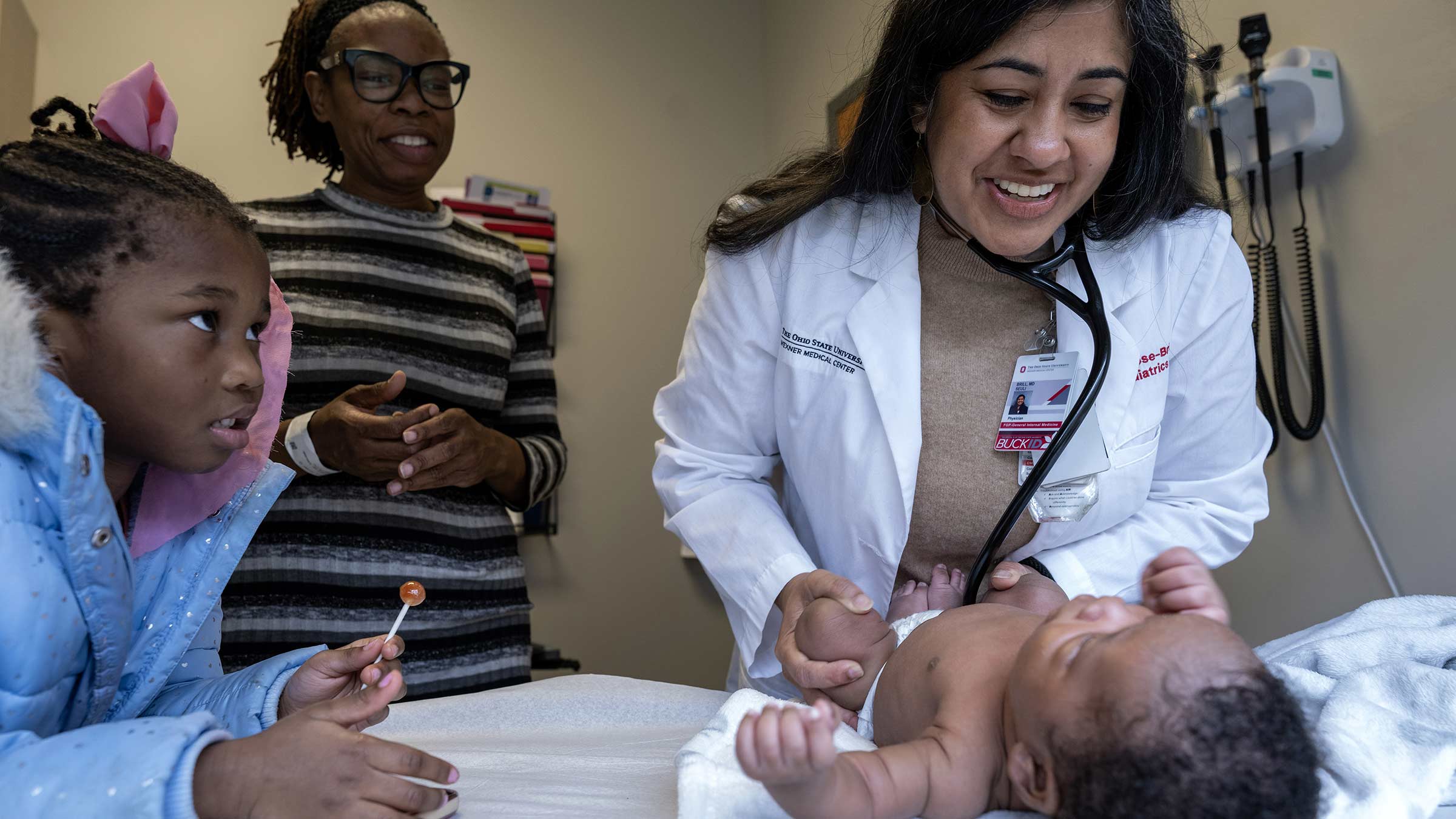 Dr. Brill examines an infant during a primary care visit with the mom and baby