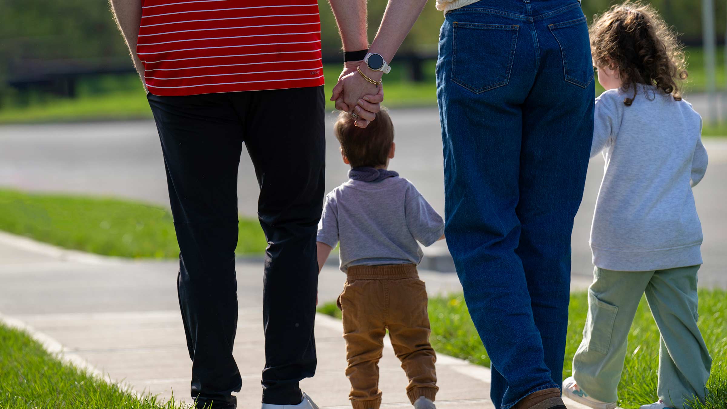 Caitlin Conner with her husband and two kids walking outside