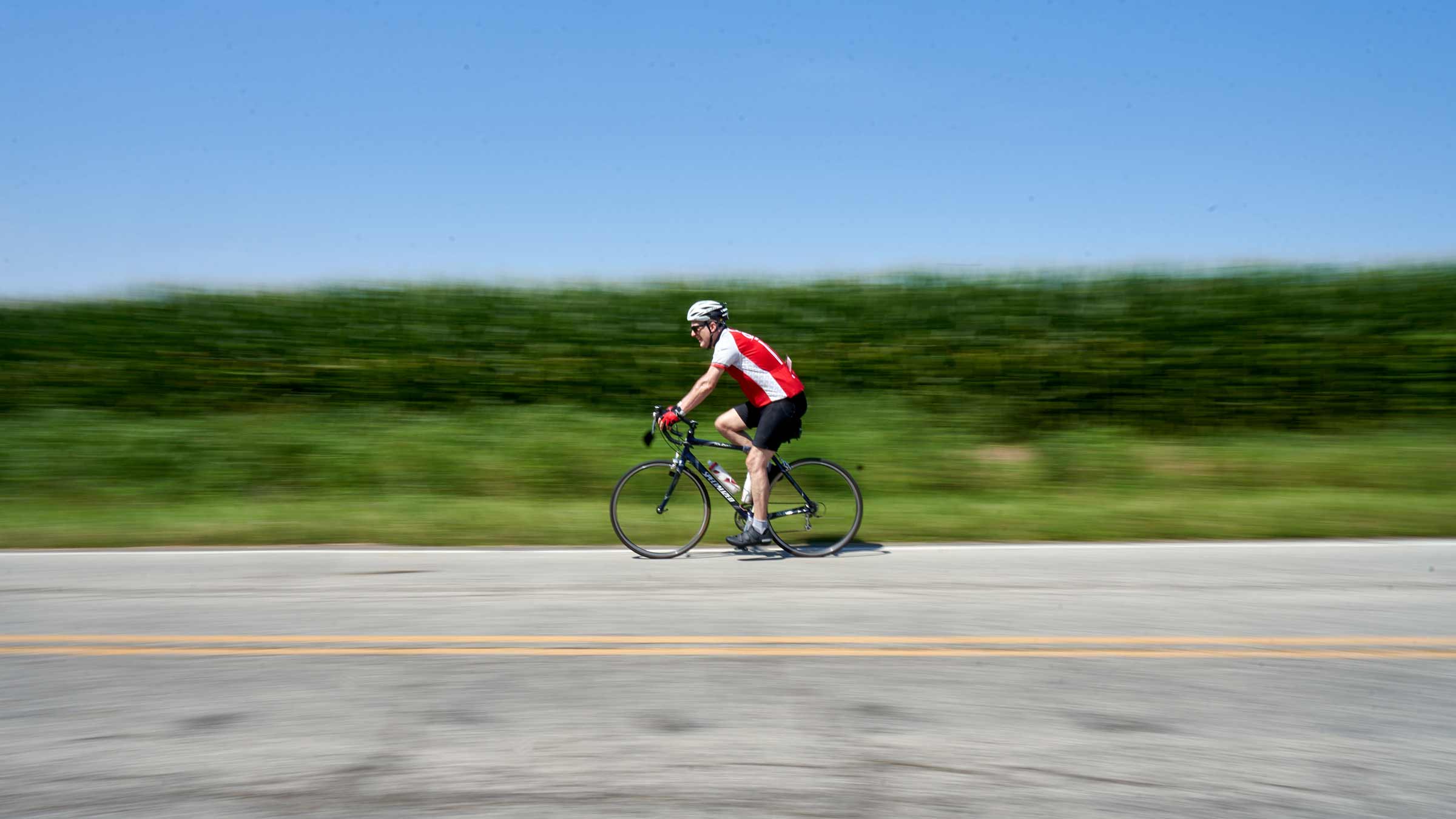 A man riding a bicycle on a local road