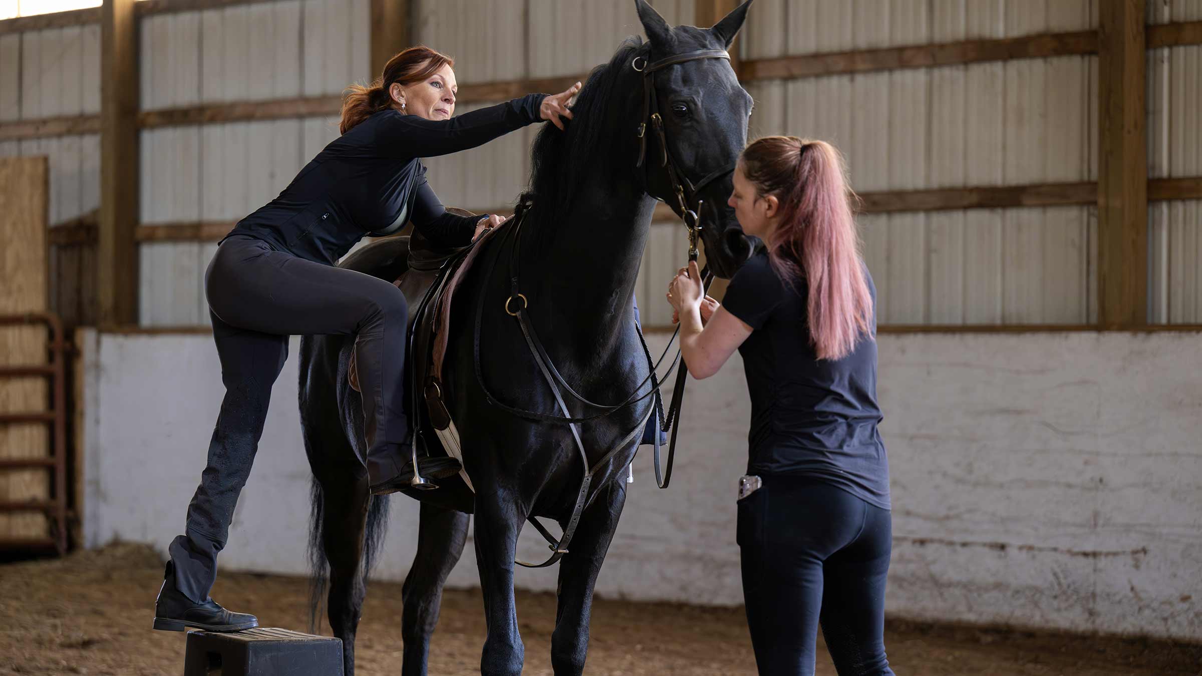 Stacey Finley mounting a horse