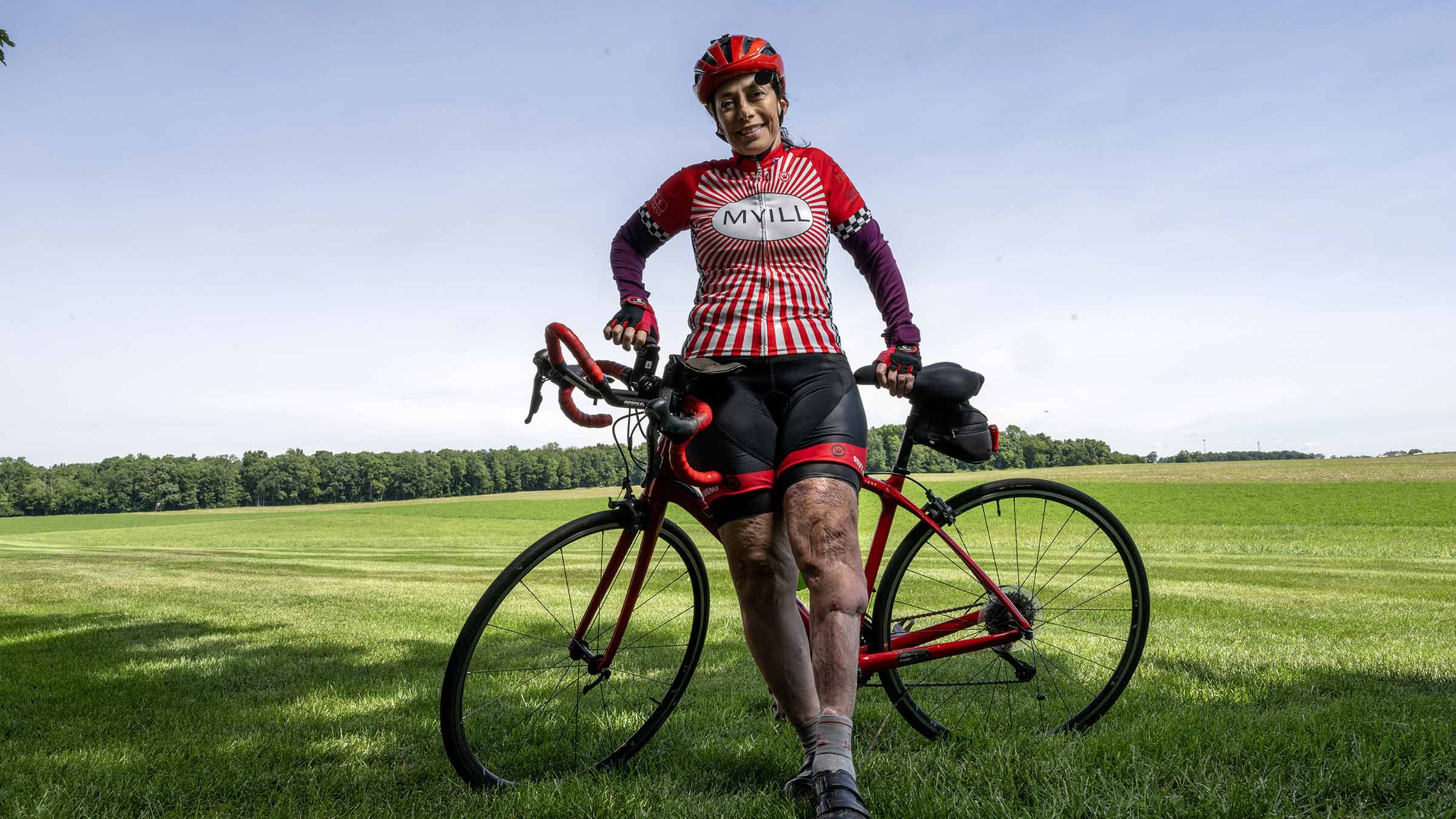 Mary Applegate standing next to her bike