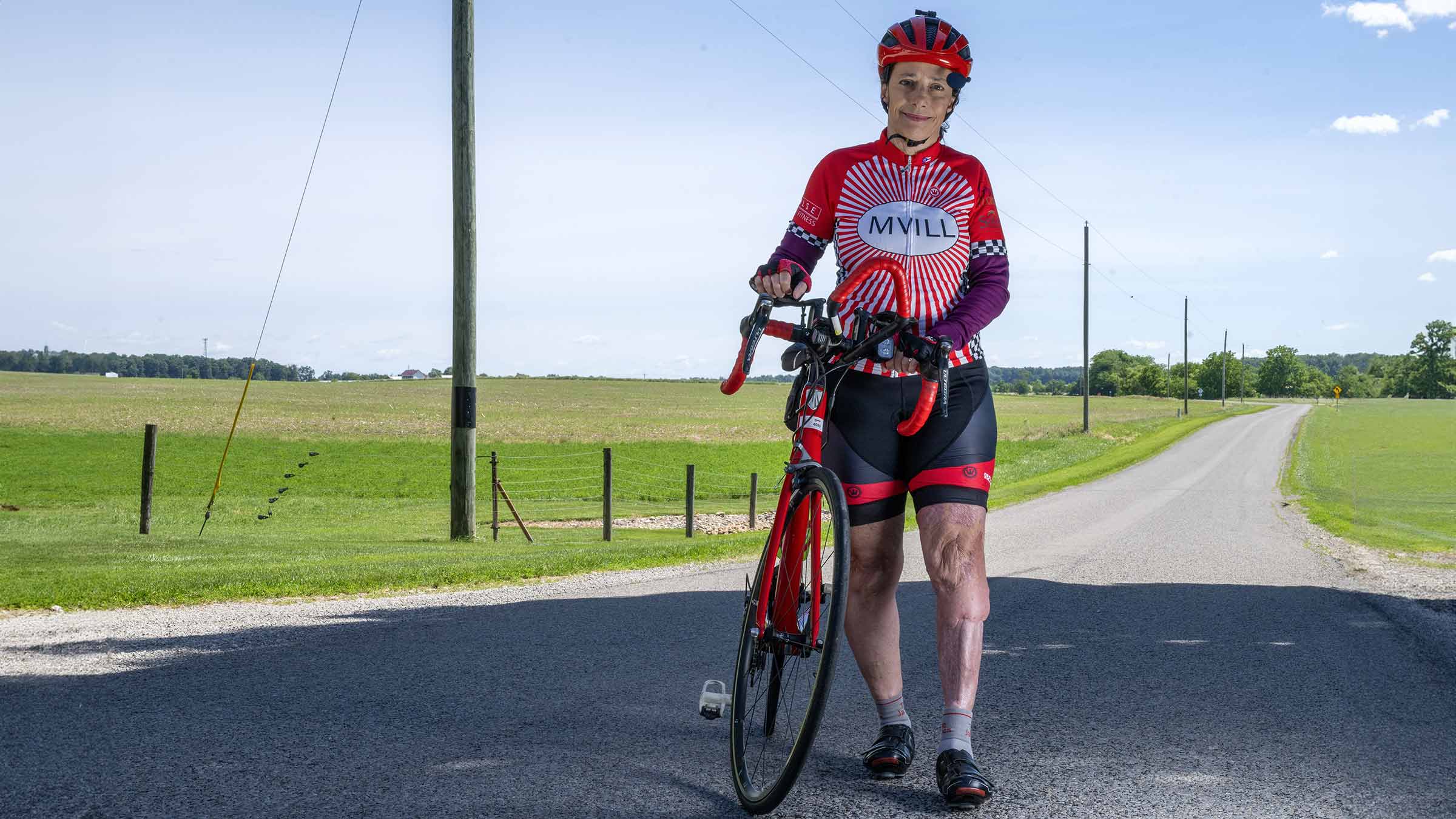 Mary Applegate standing next to her bike on the road