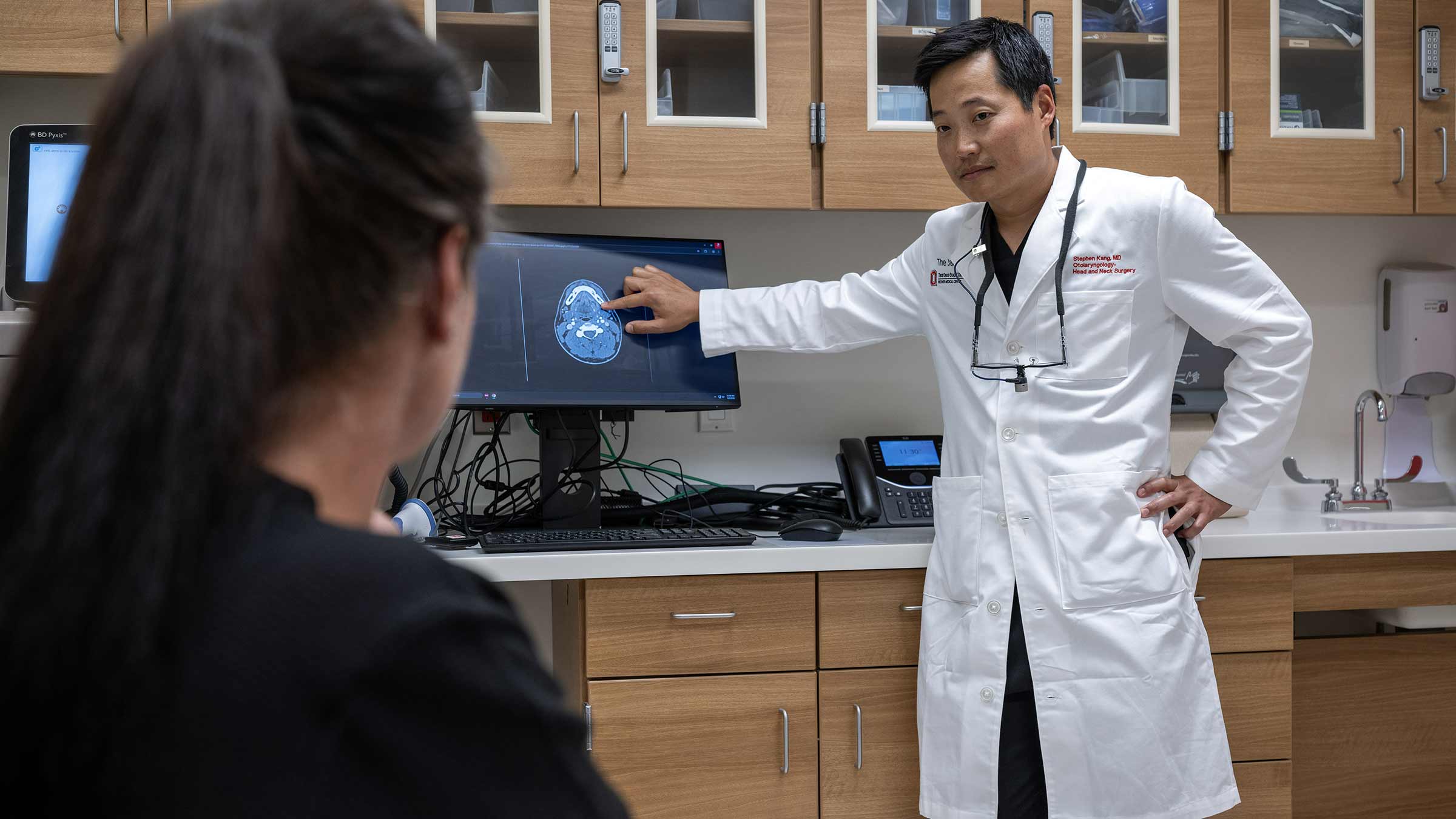 Dr. Steven Kang reviewing a scan with a patient