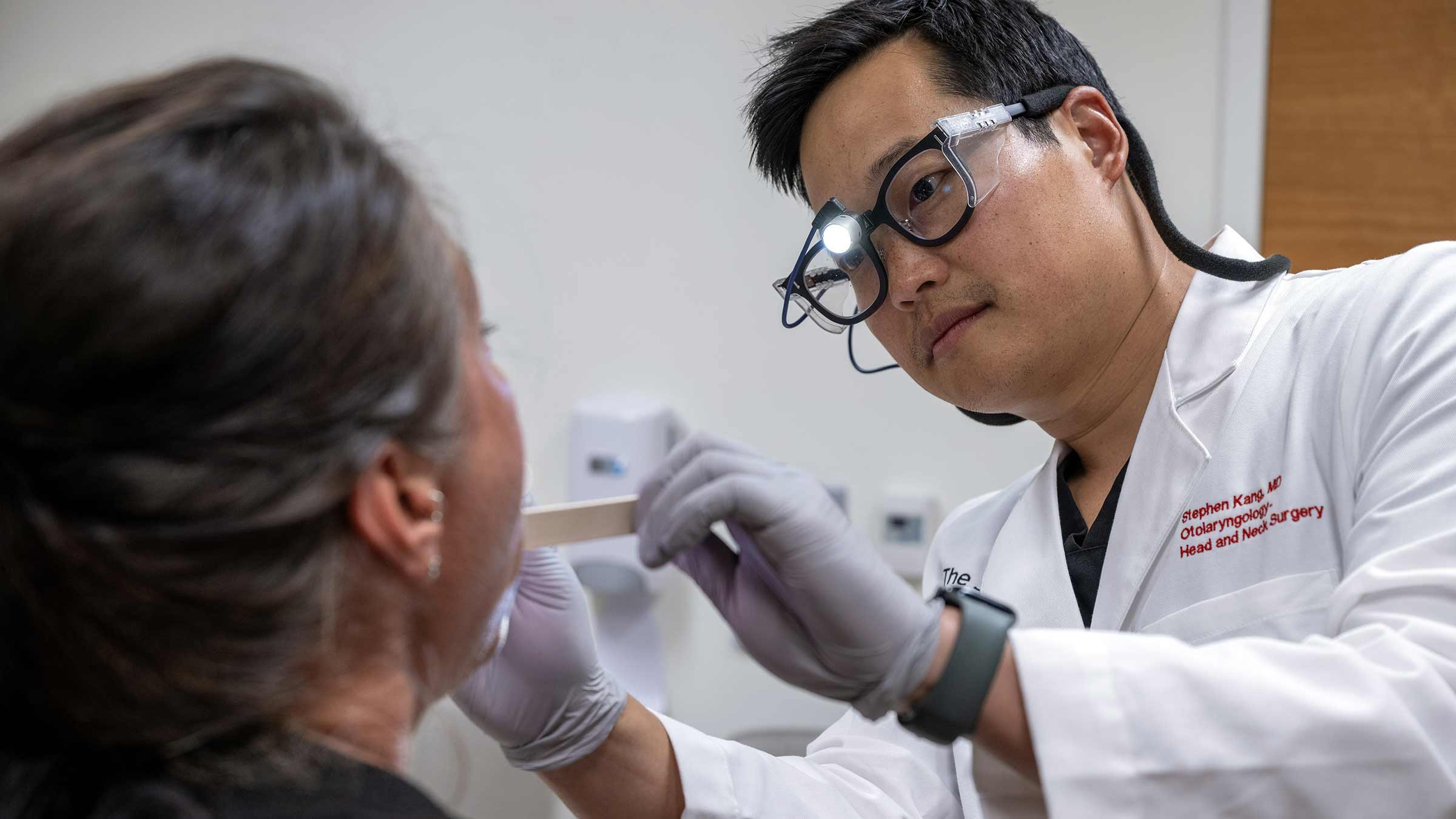 Dr. Steven Kang examining a patient