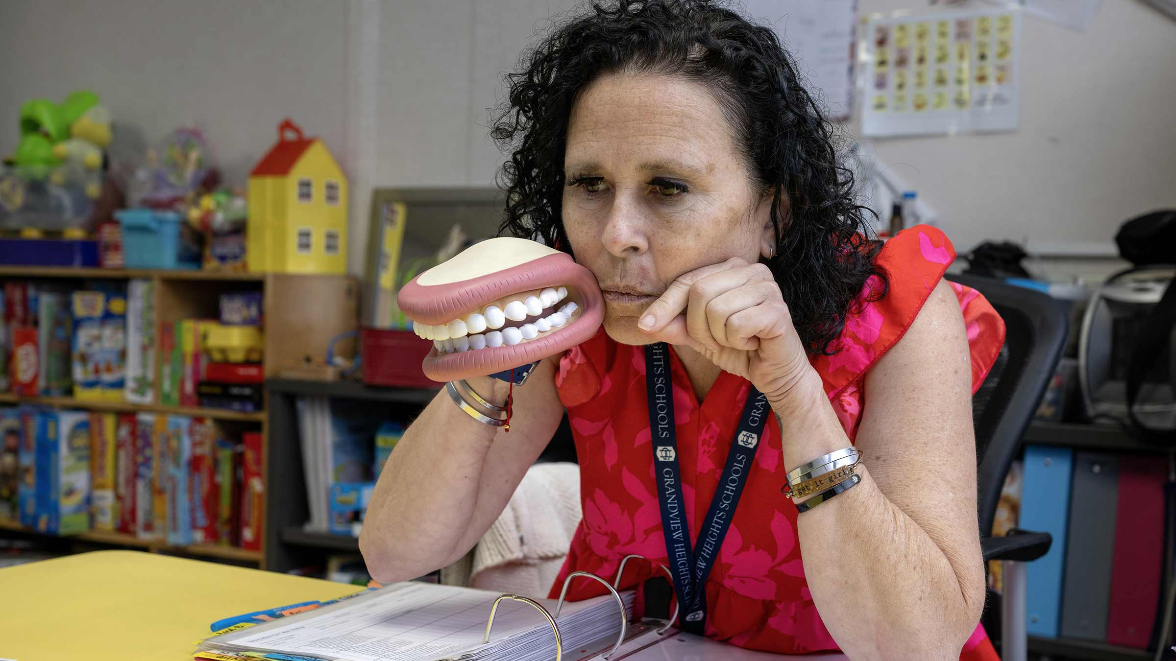 Tongue cancer survivor, Elizabeth Mora, holding a speech therapy model of a human mouth