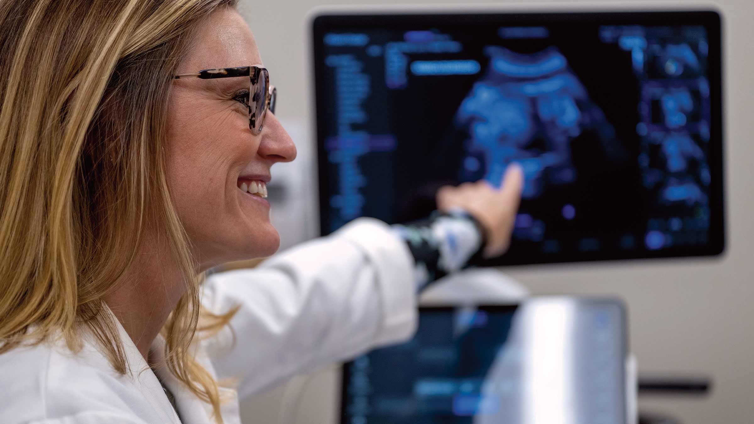 Dr. Bethany Stetson points to an ultrasound image on a computer screen